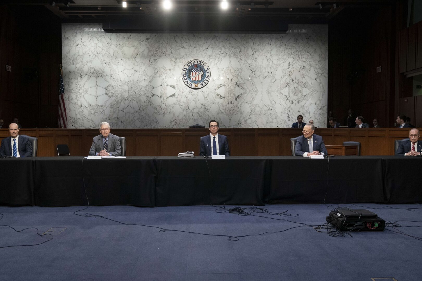 Socially distanced apart, Secretary of Labor Eugene Scalia, Senate Majority Leader Mitch McConnell, R-Ky., Treasury Secretary Steven Mnuchin, Senate Minority Leader Charles E. Schumer, D-N.Y., and National Economic Council Director Larry Kudlow attend a working group of senators and administration officials negotiating a stimulus package on Friday. 