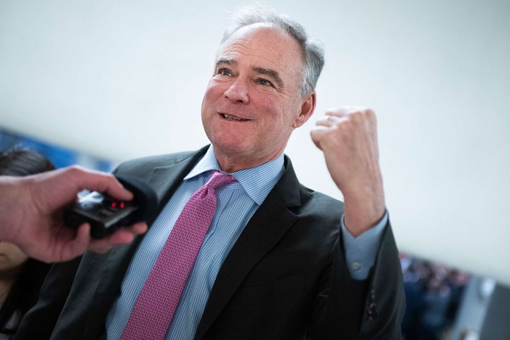 Sen. Tim Kaine, D-Va., talk with reporters in the senate subway in January. 