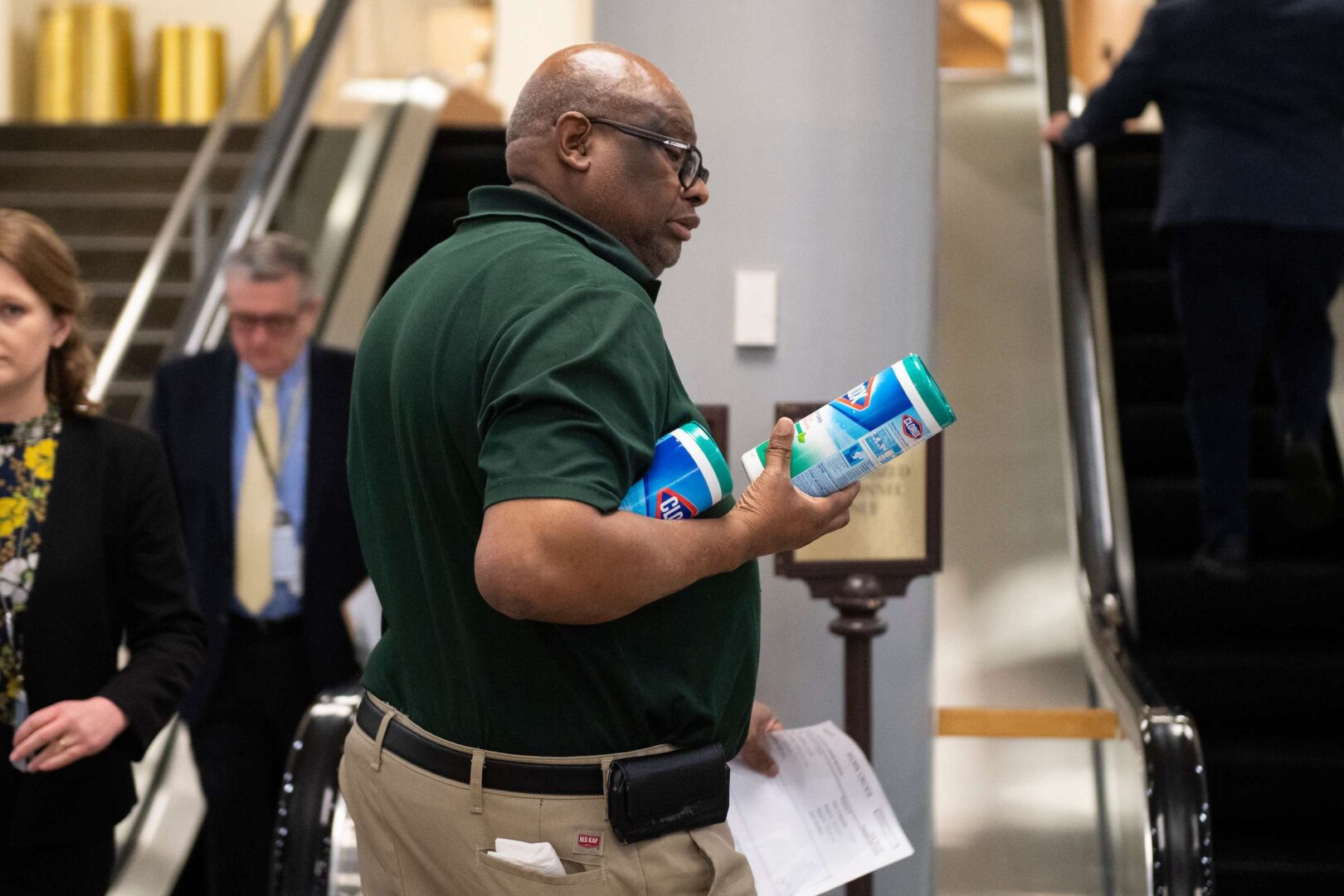 A Capitol worker holds two containers of Clorox wipes as he walks through the Senate subway on Thursday. Press members received new guidelines Monday as coronavirus cases and self-quarantine announcements continued to pop up on the Hill. 