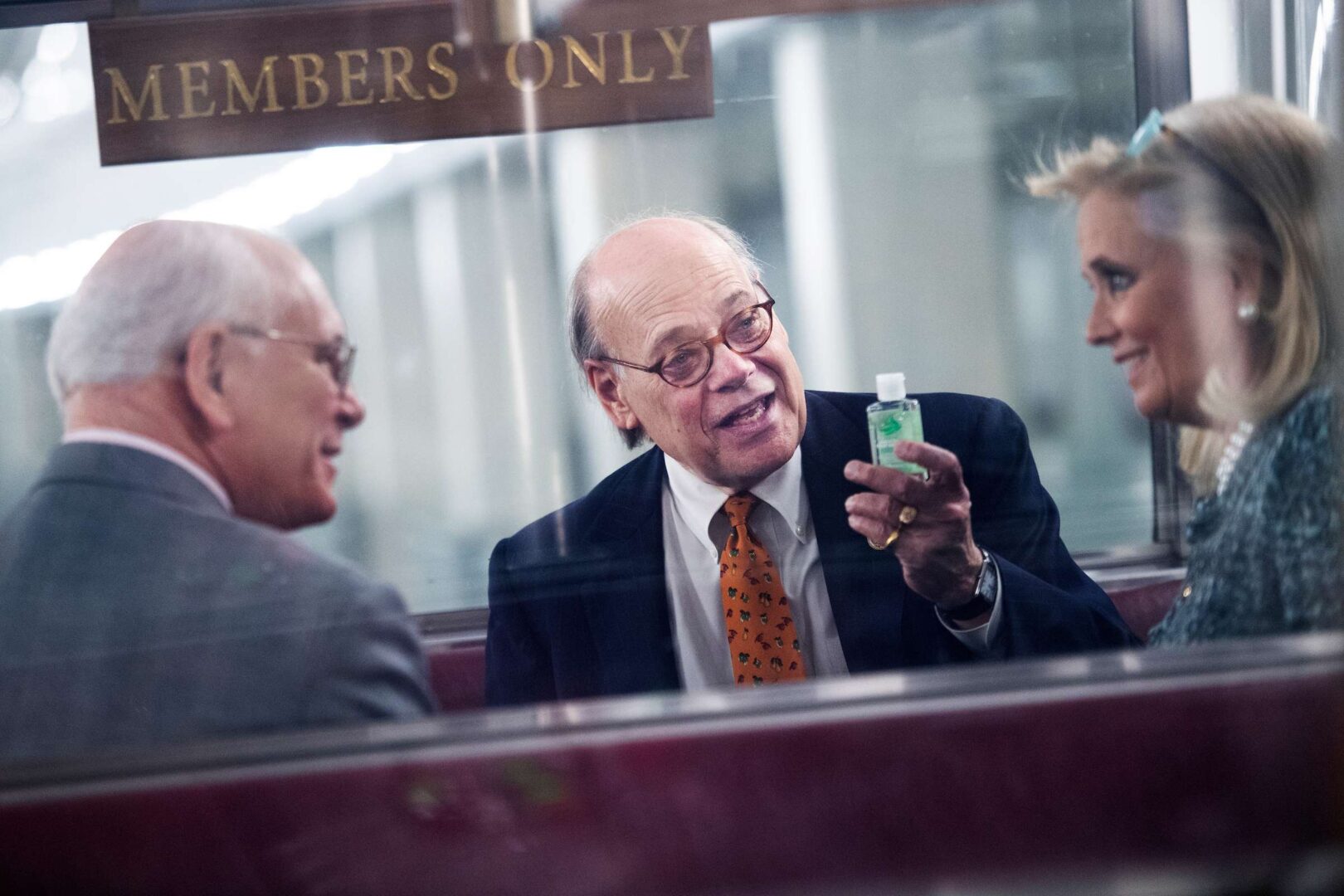UNITED STATES - MARCH 4: Rep. Steve Cohen, D-Tenn., shows his hand sanitizer that he carries as precaution to the coronavirus outbreak, to Reps. Debbie Dingell, D-Mich., and Paul Tonko, D-N.Y., in the Rayburn Building subway on Wednesday, March 4, 2020. (Photo By Tom Williams/CQ Roll Call)