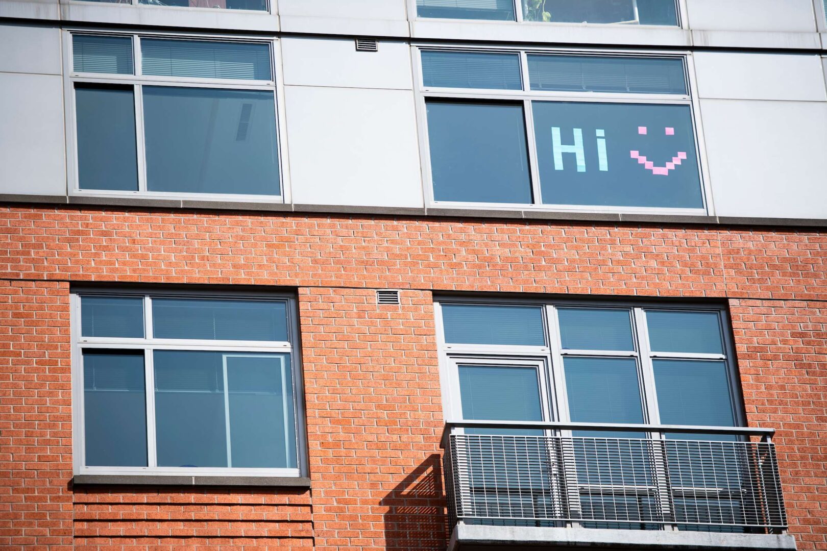 A D.C. dweller working from home says hi to their neighbors with notes on a window.  