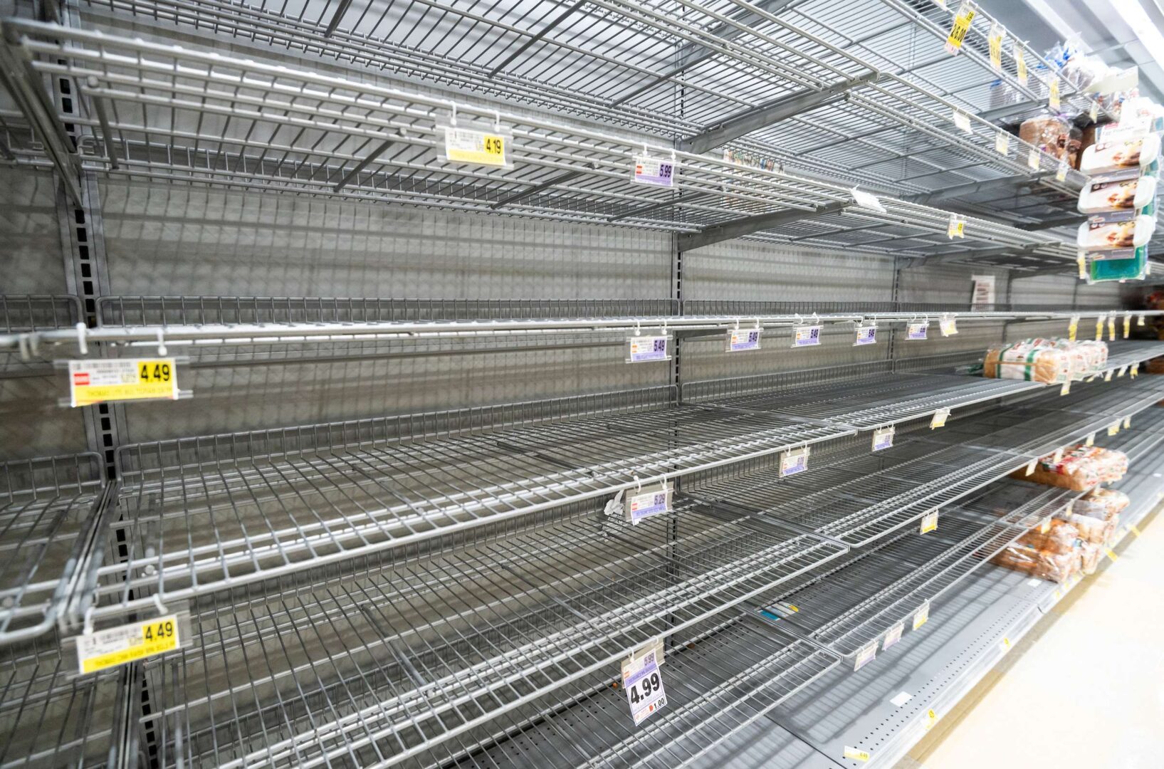 The bread aisle is mostly bare at a Harris Teeter grocery store in Washington on March 19, 2020. 