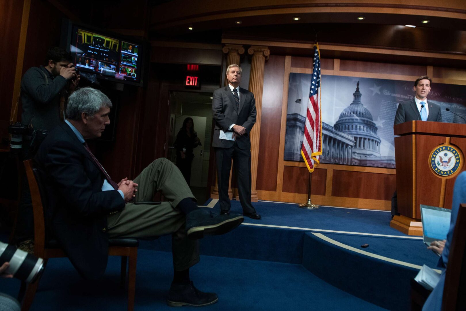 Sen. Lindsey Graham, R-S.C., center, and Sen. Ben Sasse, R-Neb., practice social distancing during a news conference on the coronavirus stimulus package in the Capitol on Wednesday.