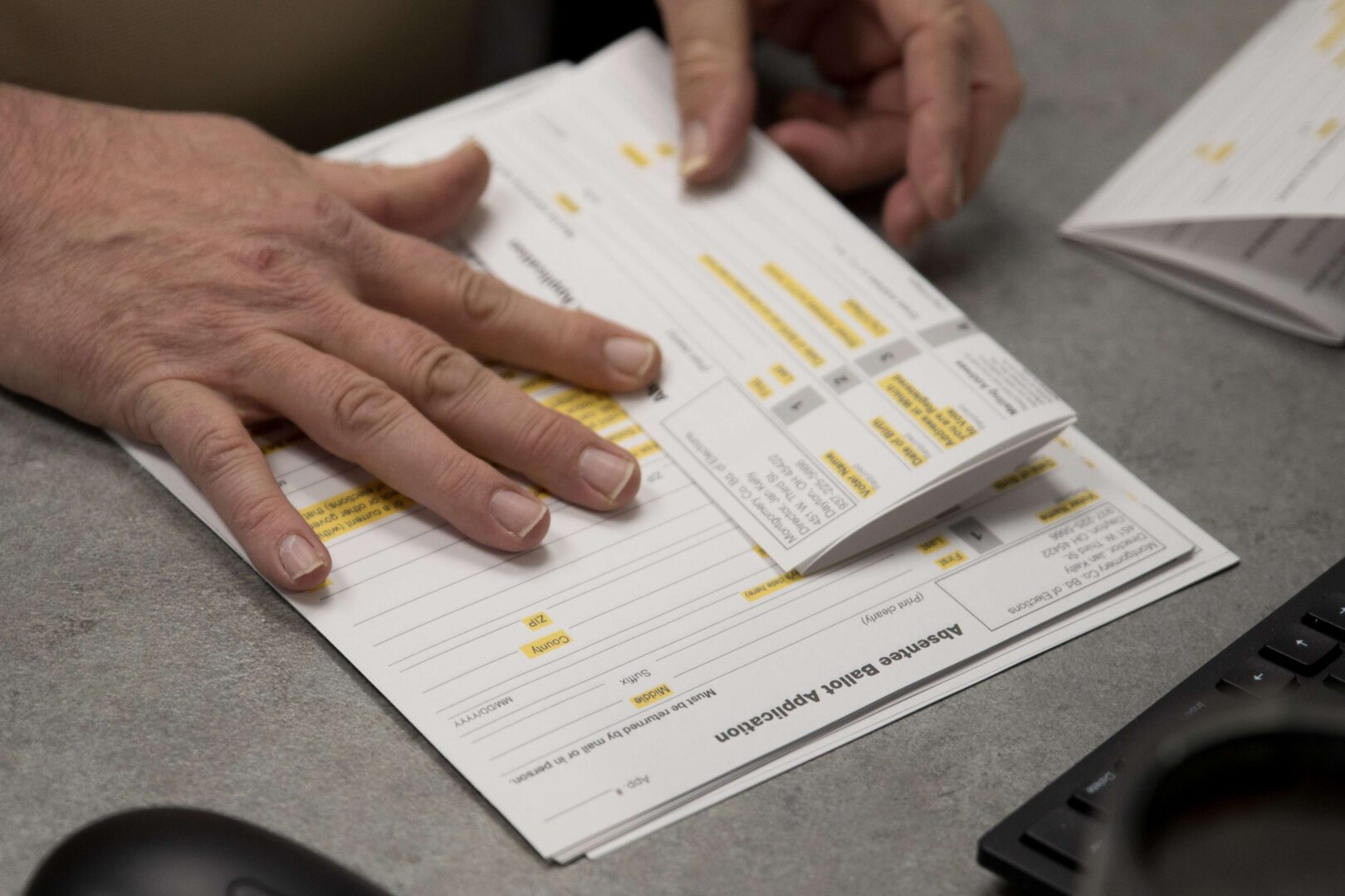 A county election worker in Dayton, Ohio, prepares absentee ballot applications in March. The state’s March 17 primary was postponed until Tuesday, with voting conducted almost entirely by mail. 