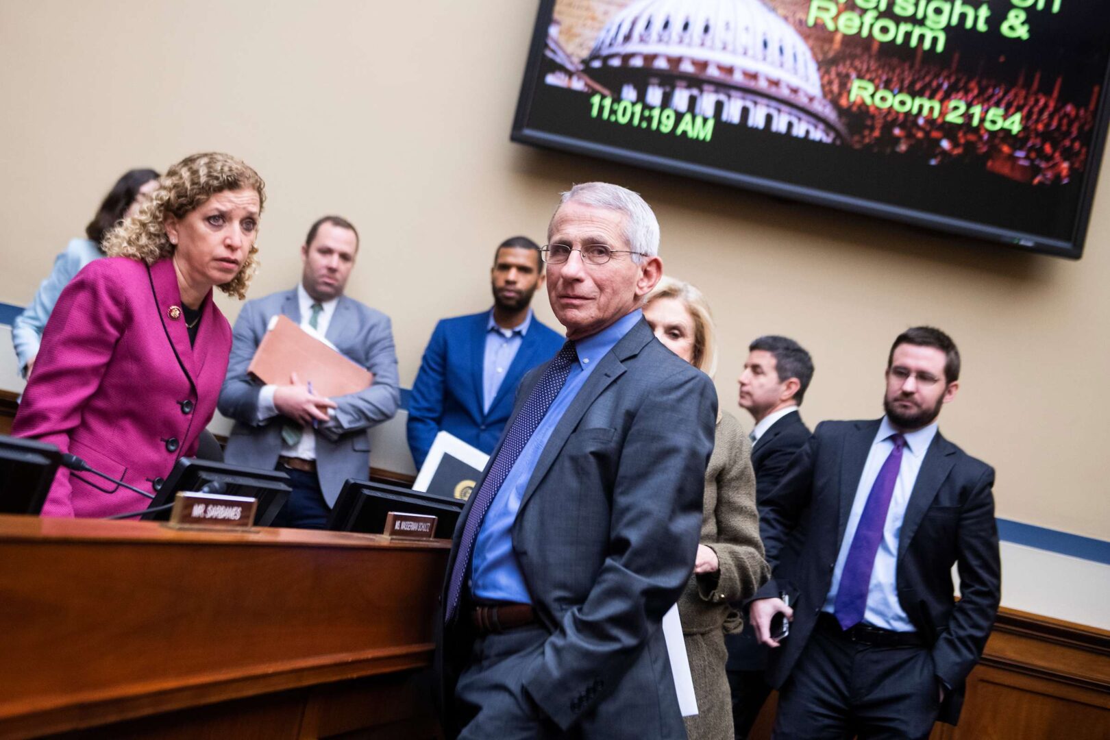 Rep. Debbie Wasserman Schultz, D-Fla., left, and Chairwoman Carolyn Maloney, D-N.Y., talk with Anthony Fauci, director of the National Institute of Allergy and Infectious Diseases on March 12, 2020. Fauci has come under fire in recent days by Trump allies and conservative media after public contradictions of the president. 