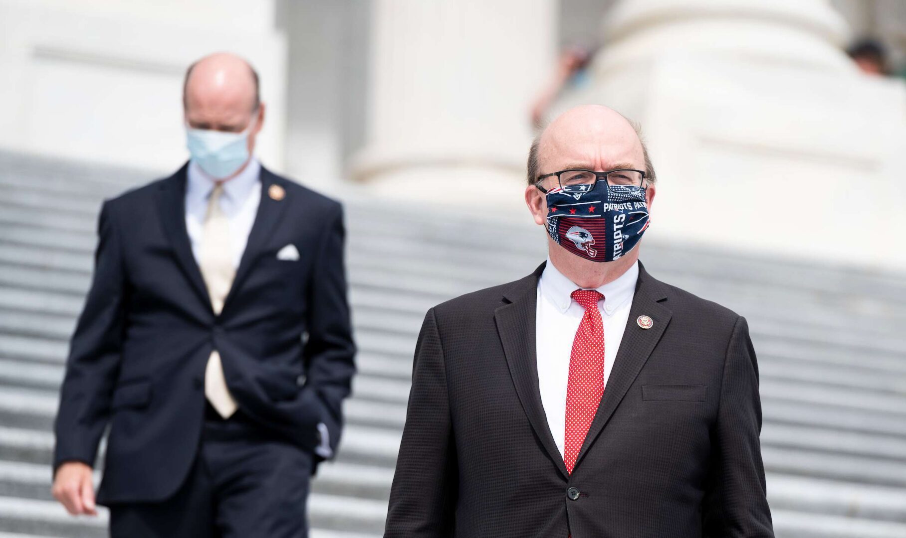 Rep. Jim McGovern, D-Mass., wearing his New England Patriots mask, walks down the House steps after voting on the rule for the Health and Economic Recovery Omnibus Emergency Solutions (HEROES) Act on Friday, May 15, 2020.