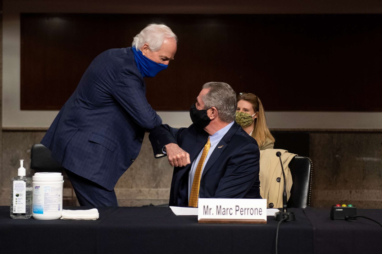 UNITED STATES - MAY 12: Sen. John Cornyn, R-Texas, left, elbow bumps Marc Perrone, International President of United Food and Commercial Workers International Union, before the start of the Senate Judiciary Committee hearing on Examining Liability During the COVID-19 Pandemic on Capitol Hill in Washington on Tuesday, May 12, 2020. (Photo by Caroline Brehman/CQ Roll Call)
