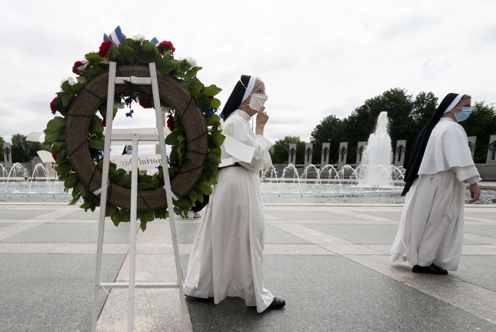 Nuns walk by the wreaths placed at the World War II Memorial in Washington on Memorial Day.