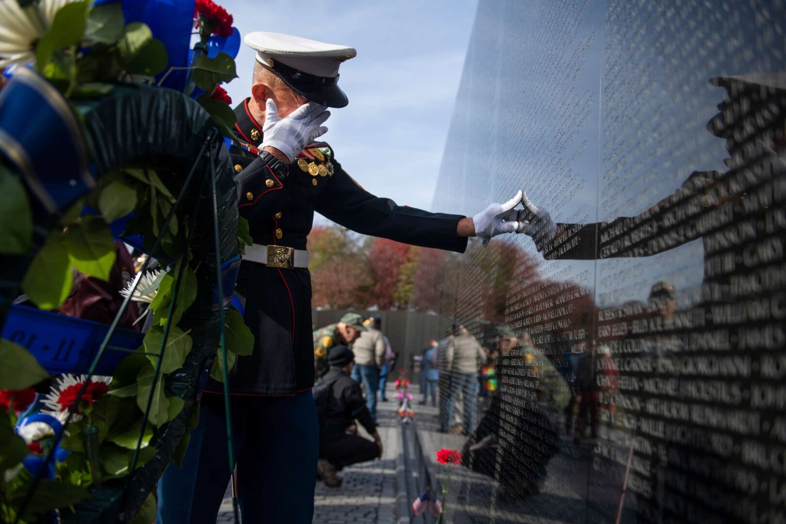 Retired Marine Paul Masi pauses by the name of a high school classmate on the Vietnam Veterans Memorial wall on Veterans Day in 2019. A bill to add the names of 74 men killed on the USS Frank E. Evans in 1969 was debated Thursday in the Senate.
