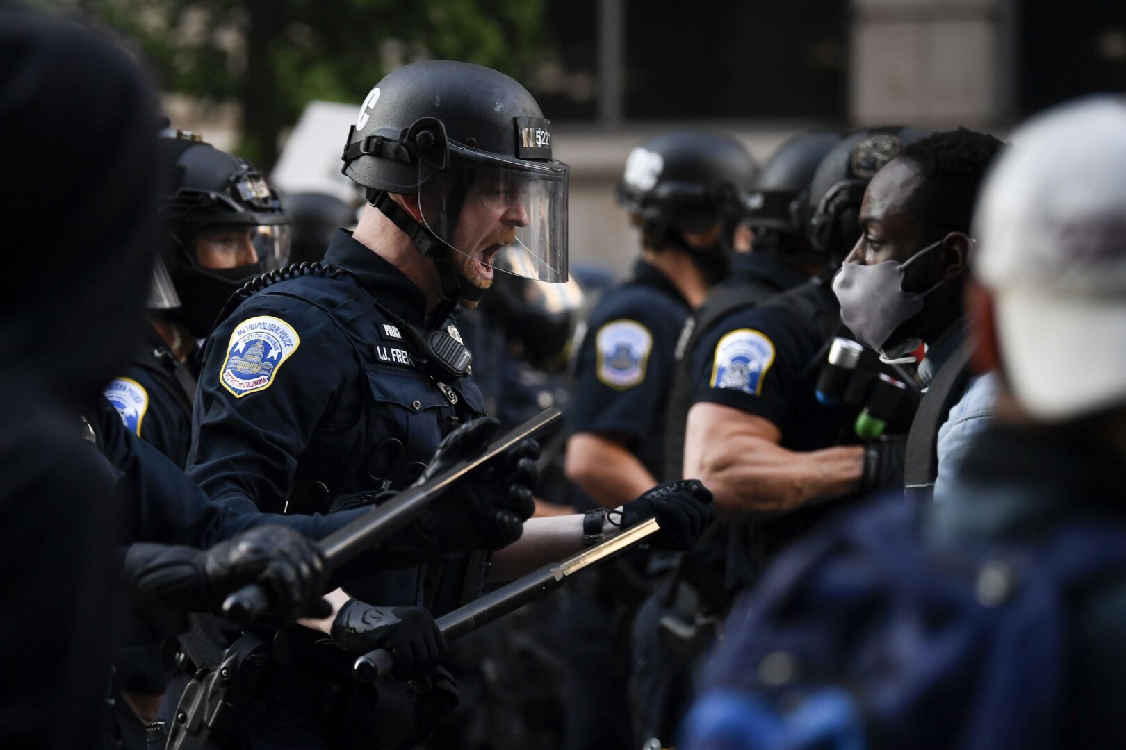 Police in riot gear react to demonstrators as they gather to protest the death of George Floyd near the White House in Washington on Sunday, May 31, 2020.