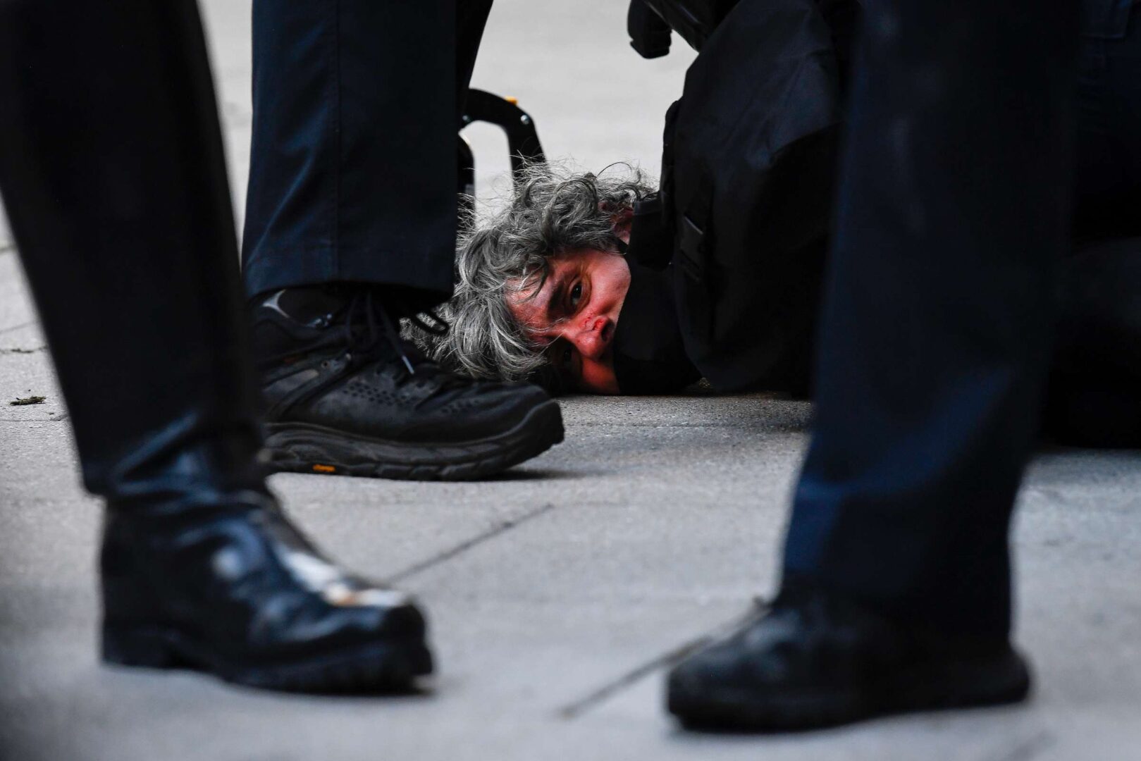 A demonstrator is detained by police near the White House on Sunday during protests over the death of George Floyd.