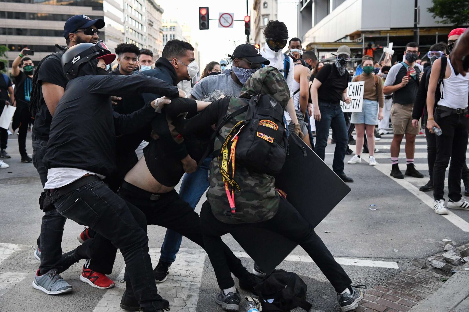 UNITED STATES - MAY 31: Demonstrators hand over a man who was about to provoke the police as people gather to protest the death of George Floyd in Washington near the White House on Sunday, May 31, 2020. (Photo by Caroline Brehman/CQ Roll Call)
