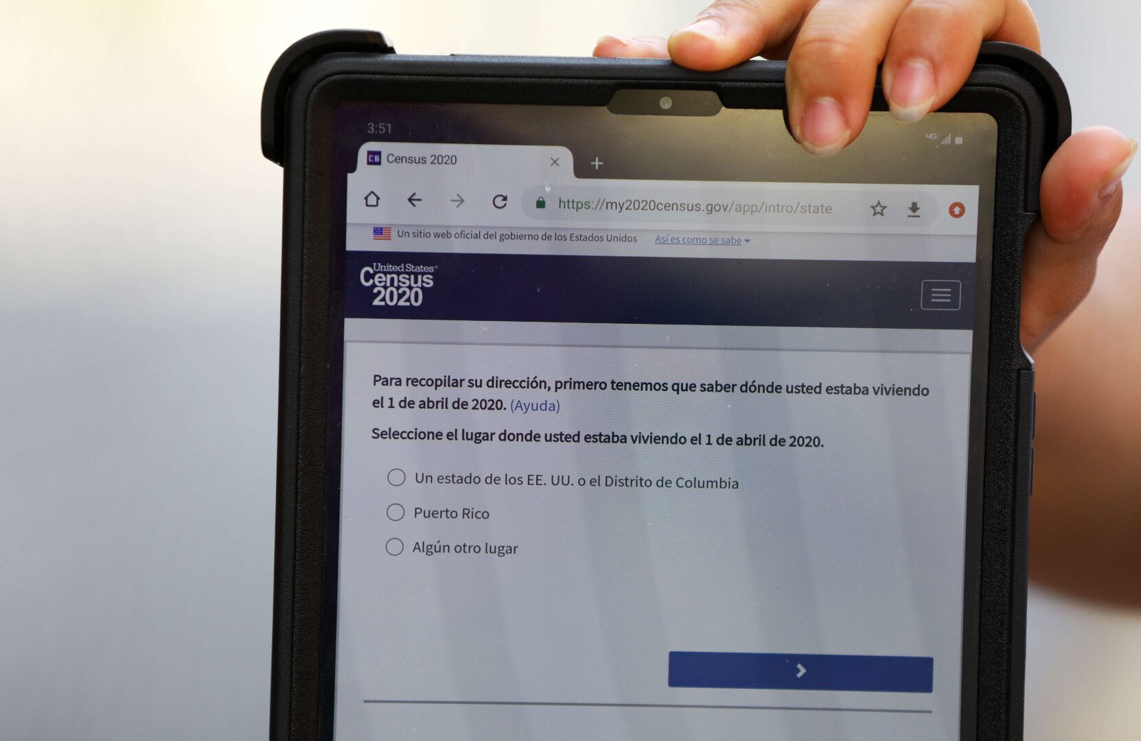 Census 2020 field organizers use tablets as they interview people in the food pantry line at the Chelsea Collaborative in Massachusetts on June 4, 2020. 
