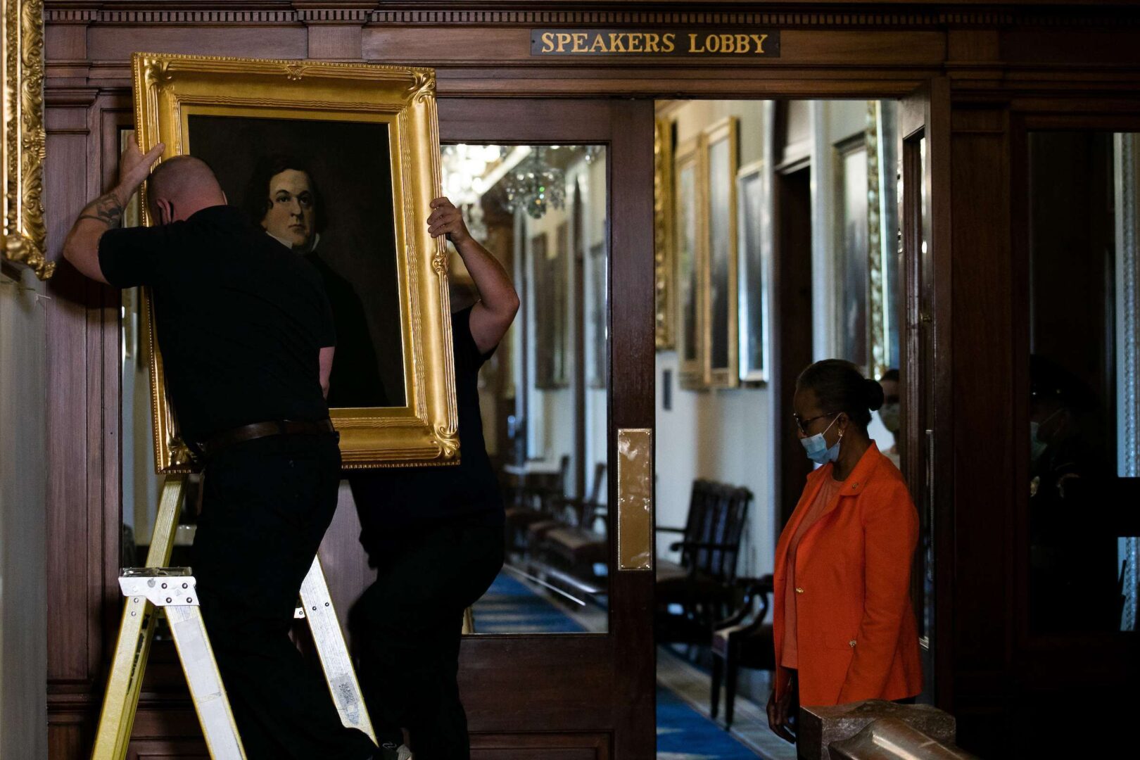 House Clerk Cheryl Johnson looks on as Architect of the Capitol maintenance workers remove a painting of Howell Cobb of Georgia, from the east staircase of the Speakers lobby, on Capitol Hill, Thursday, June 18, 2020. Photo by Graeme Jennings/Washington Examiner/POOL