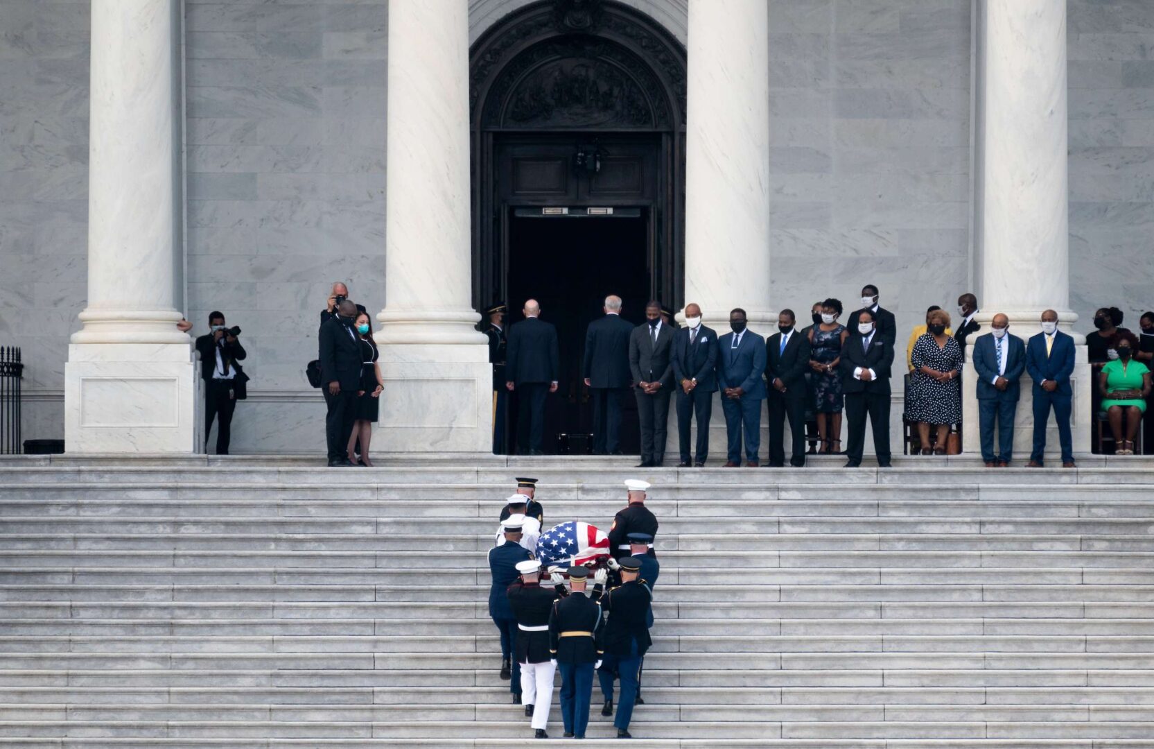 The military honor guard carries the casket of the late Rep. John Lewis on Monday up the steps of the Capitol, where he will lie in state Monday and Tuesday.