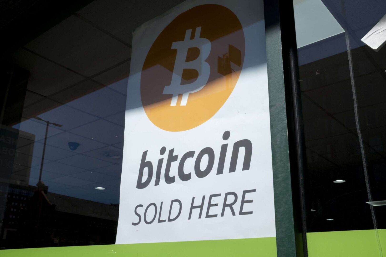 A sign advertising bitcoin in a small shop window in Birmingham, United Kingdom.