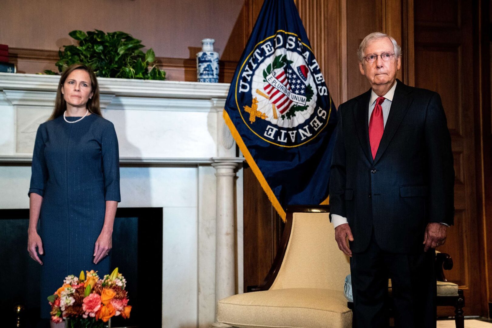 Senate Majority Leader Mitch McConnell, here with Supreme Court nominee Amy Coney Barrett in the Capitol on Tuesday, says the chamber will be in next week, despite the recent spate of positive coronavirus tests.