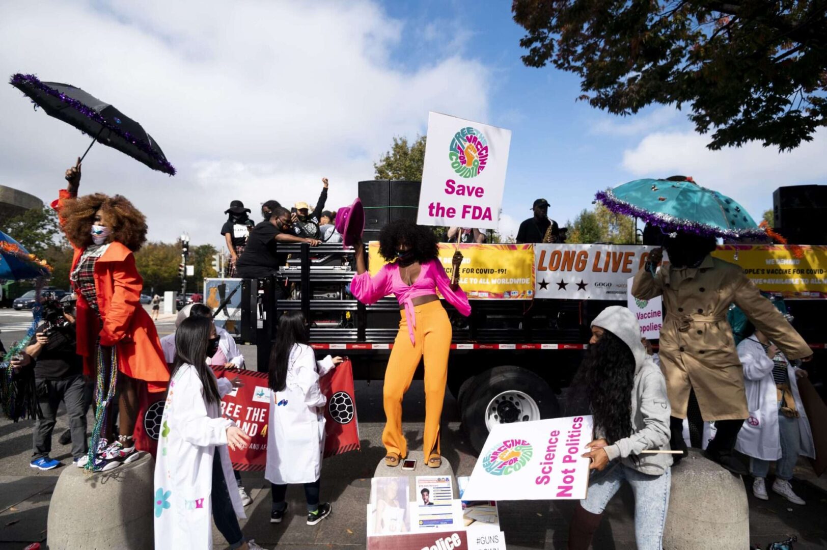 Vaccine affordability protesters dance as the Long Live GoGo band plays outside of the Department of Health and Human Services building in Washington on Wednesday, Oct. 21, 2020. The protest was held to call for safe and free Covid-19 vaccines. (Bill Clark/CQ Roll Call)