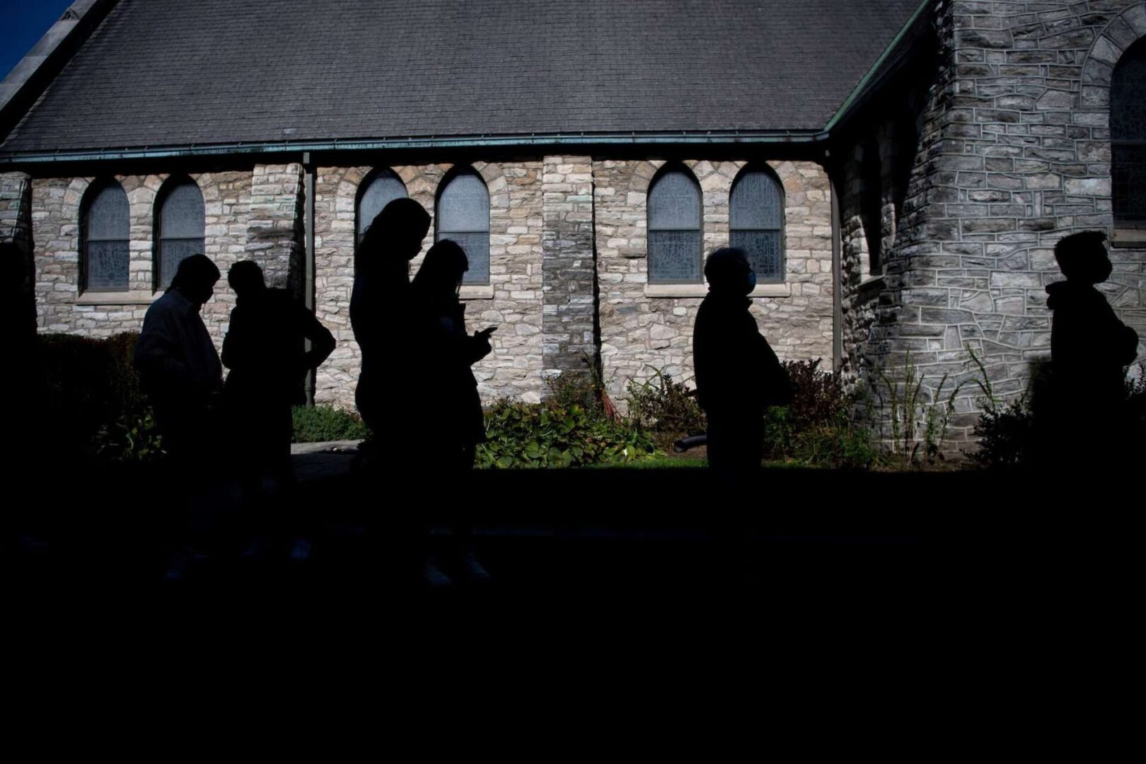People wait in line to cast their votes at St. Mary’s Episcopal Church in Wayne, Pa., on Nov. 3.