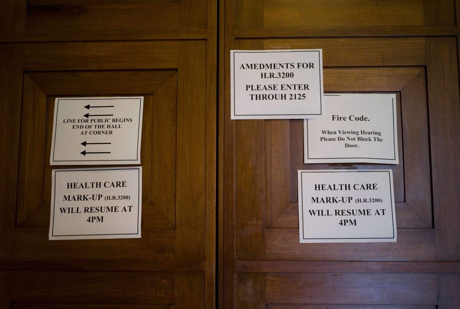 Signs on the door of the House Energy and Commerce meeting room amid delays for a 2009 markup of the health care overhaul.
