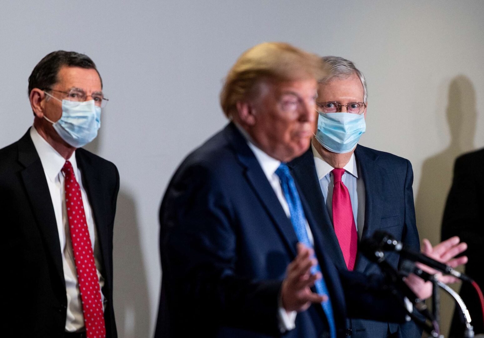 President Donald Trump, flanked by Sen. John Barrasso, R-Wyo., and Senate Majority Leader Mitch McConnell, R-Ky., speaks he departs the Senate Republicans' policy lunch in the Hart Senate Office building on May 19.
