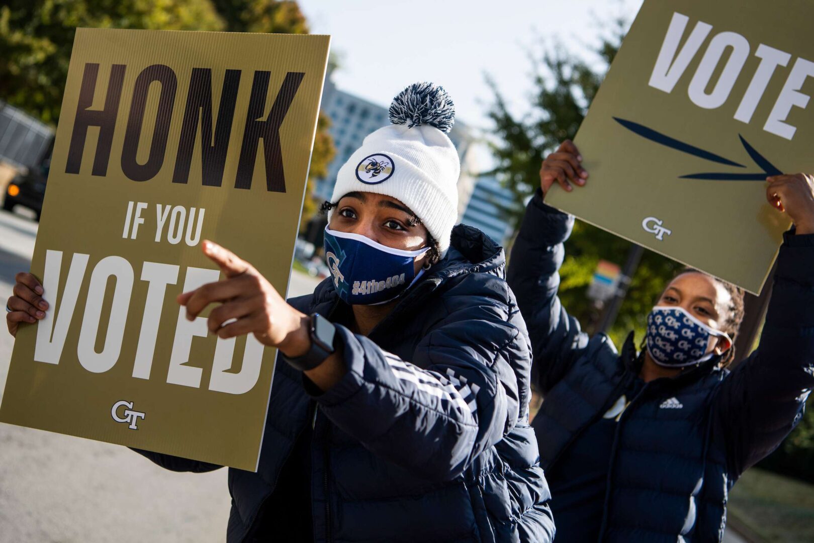 Members of the Georgia Tech women's basketball team hold voting signs outside of a polling place on Election Day in Nov. 3.