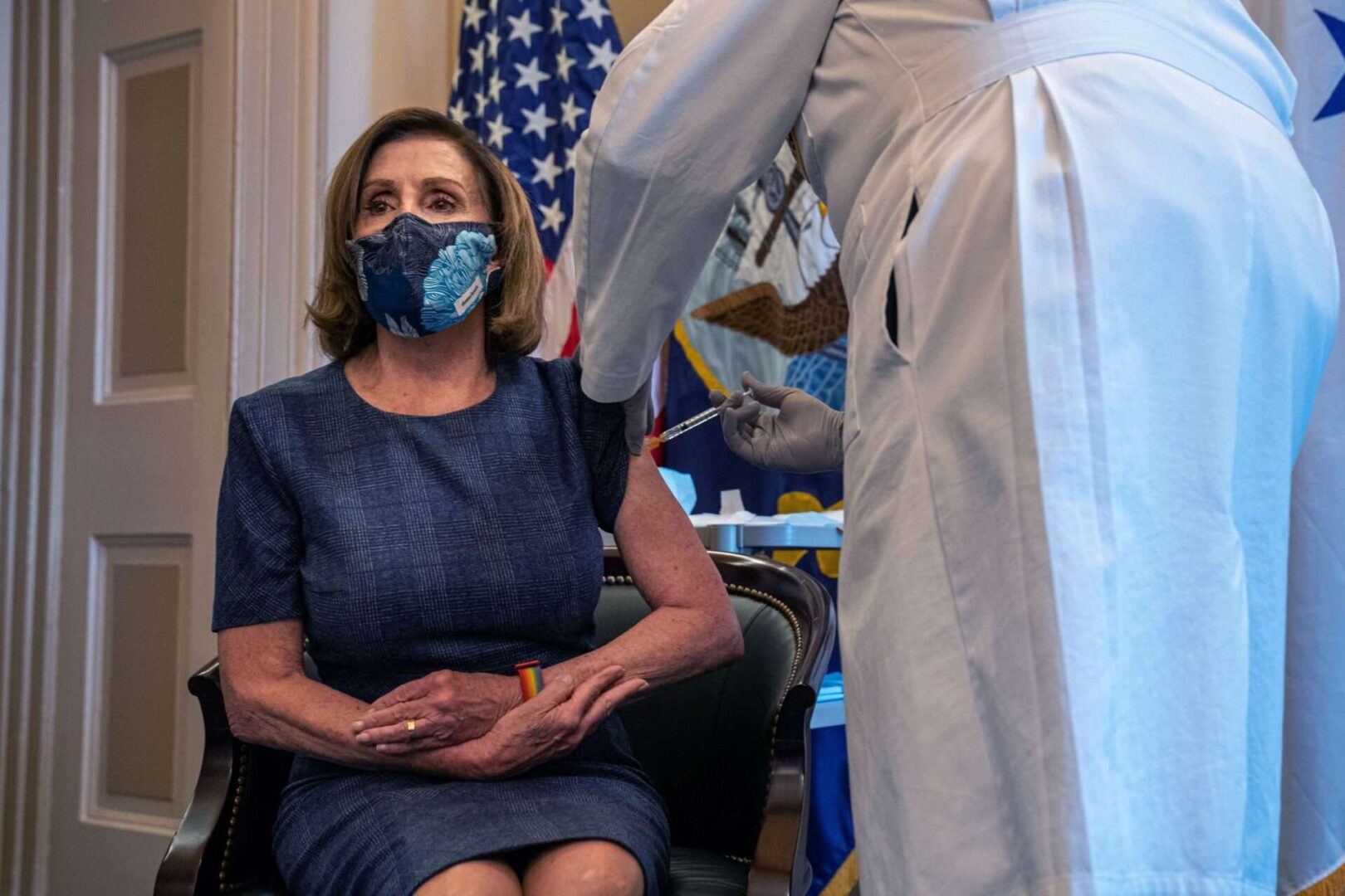 Speaker Nancy Pelosi, D-CA., receives a COVID-19 vaccination shot by Dr. Brian Monahan, attending physician Congress of the United States in her office in Washington, D.C. on Friday.