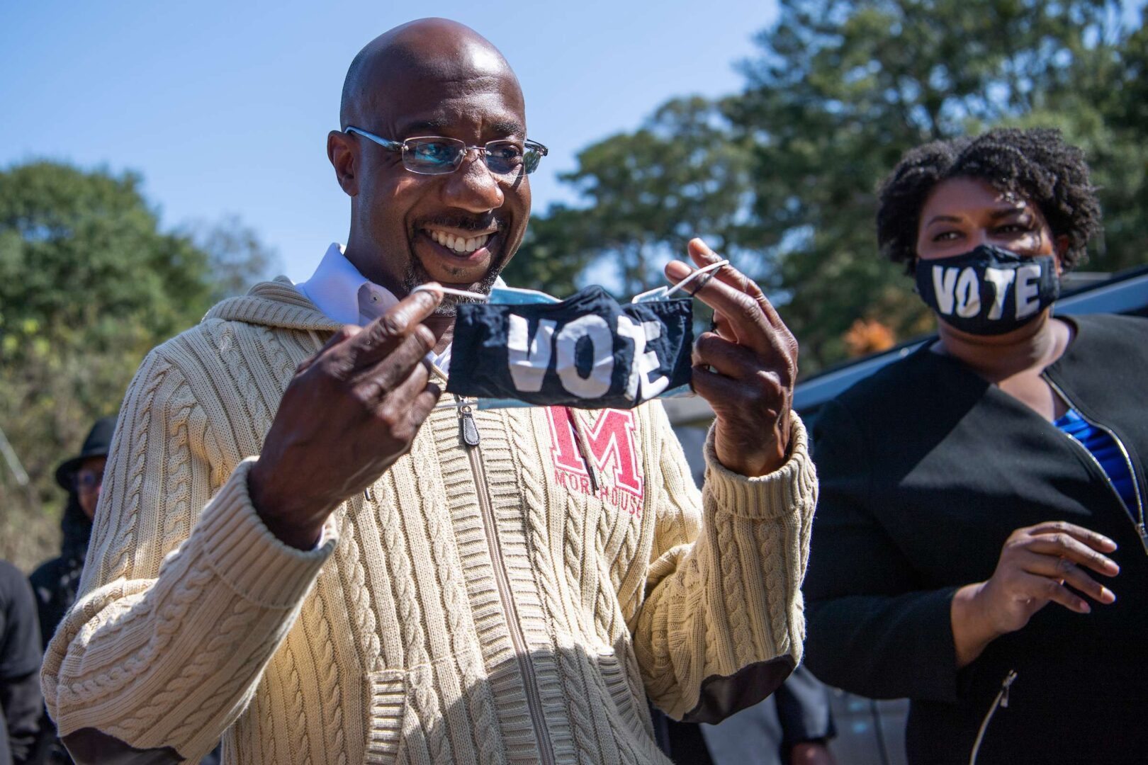 Raphael Warnock campaigns with fellow Georgia Democrat Stacey Abrams in Atlanta on Nov. 3. Warnock and Democrat Jon Ossoff won a pair of Senate runoffs Tuesday, allowing their party to retake the chamber. 