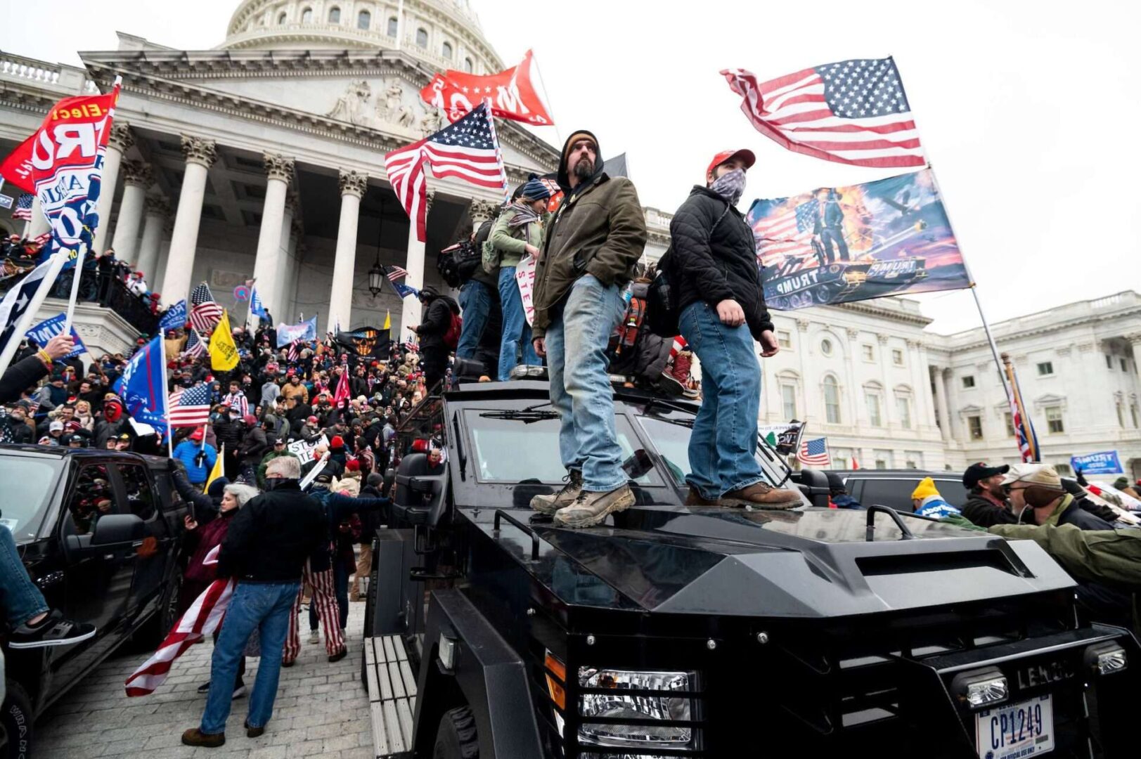 Trump supporters stand on a Capitol Police armored vehicle Wednesday as others take over the steps of the Capitol as Congress worked to certify the Electoral College votes.