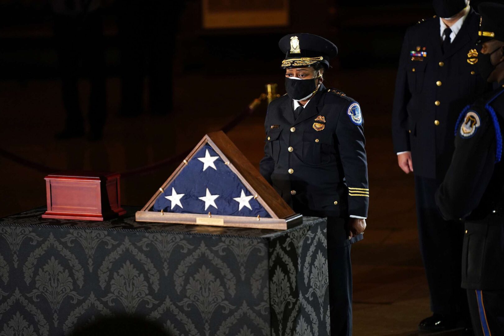 US Capitol Police Acting Chief Yogananda Pittman pays her respects to the late Capitol Police officer Brian Sicknick as they lie in honor in the Rotunda of the Capitol in Washington, DC on Tuesday. Sicknick died on Jan. 7 after engaging with rioters on Jan. 6 while protecting the Capitol. 