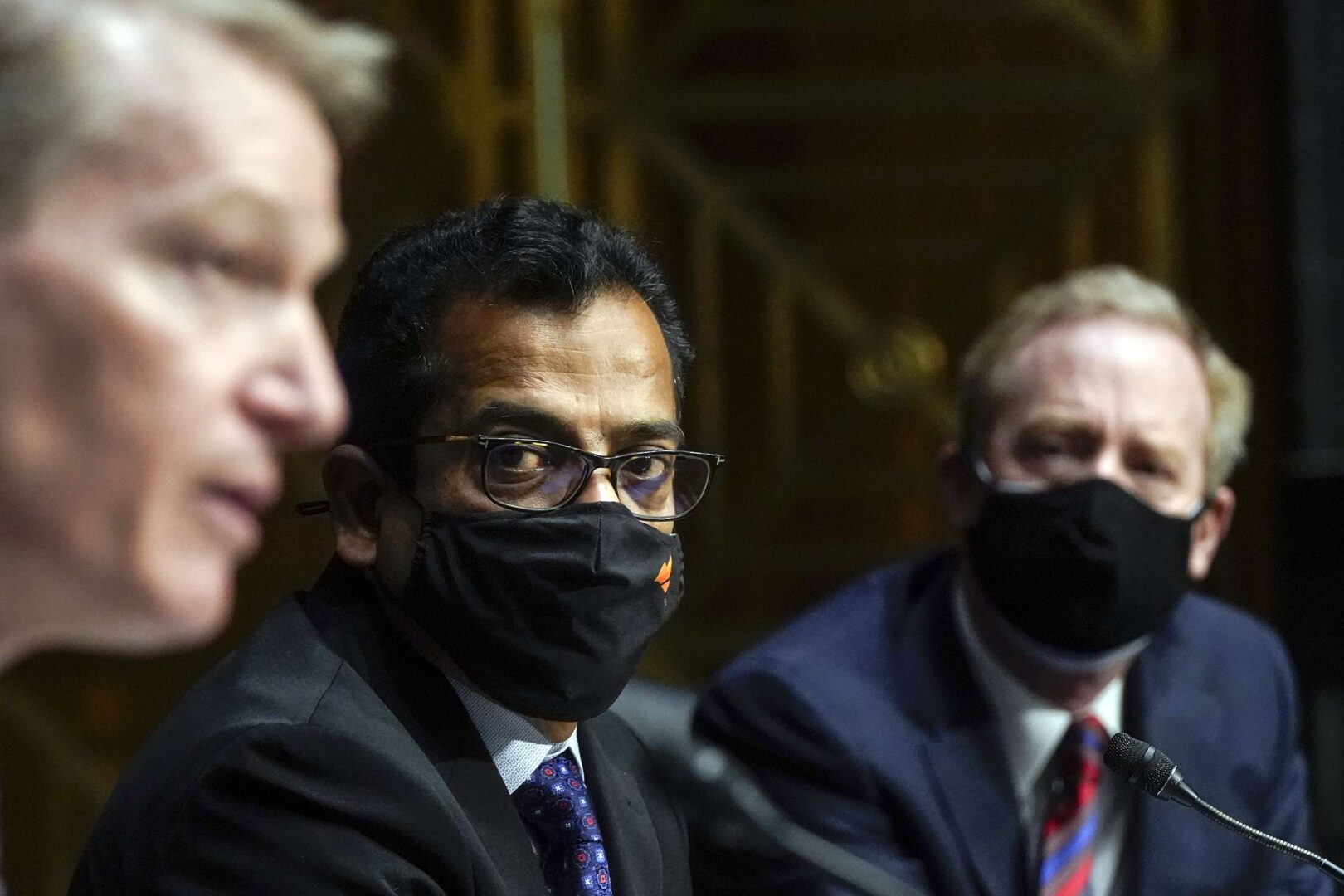 From left, FireEye CEO Kevin Mandia, SolarWinds CEO Sudhakar Ramakrishna and Microsoft CEO Brad Smith testify during a Senate Intelligence Committee hearing on Feb. 23, 2021.