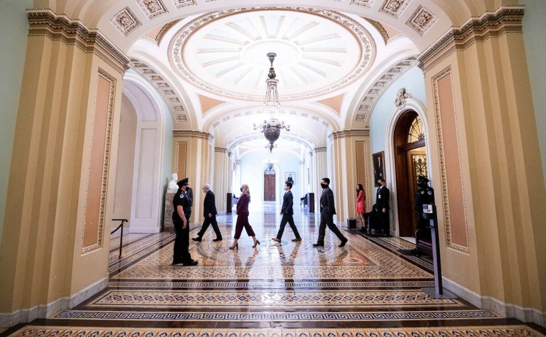 UNITED STATES - MARCH 23: Senate Minority Leader Mitch McConnell, R-Ky., followed by his staff walks through the Ohio Clock Corridor from the Senate chamber back to his office on Tuesday, March 23, 2021. (Photo By Bill Clark/CQ Roll Call)