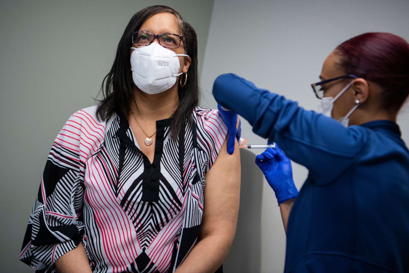 Michelle Byers receives her first Moderna vaccination shot from her daughter Ashleigh Byers at Greater Baden Medical Services in Brandywine, Md., on April 8.