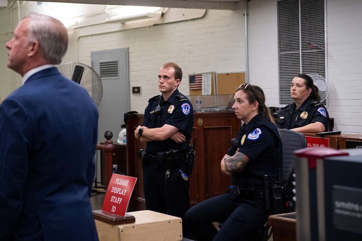 U.S. Capitol Police officers on Tuesday watch a monitor of the House Jan. 6 select committee hearing to examine the attack on the Capitol.