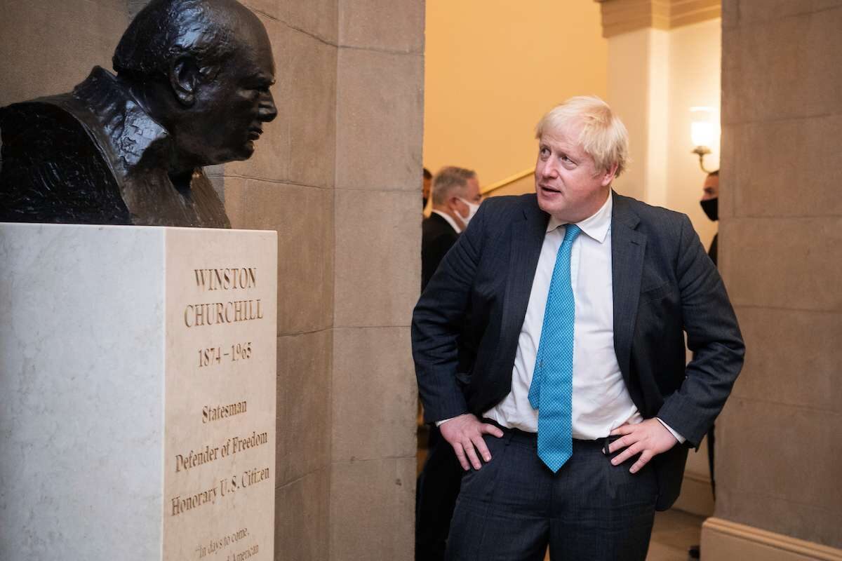 British Prime Minister Boris Johnson checks out a bust of Winston Churchill  after a meeting with Speaker Nancy Pelosi, D-Calif., in the U.S. Capitol on Wednesday.