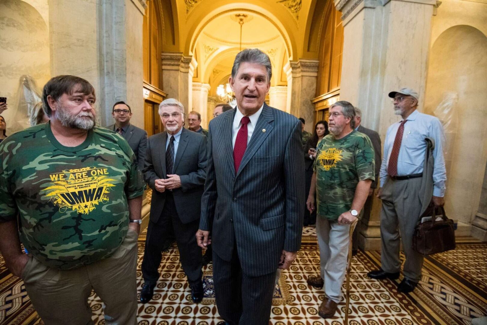 Sen. Joe Manchin III, center, and Cecil Roberts, president of the United Mine Workers of America, arrive at the Capitol in October 2017 to hold a news conference on the introduction of a bill.