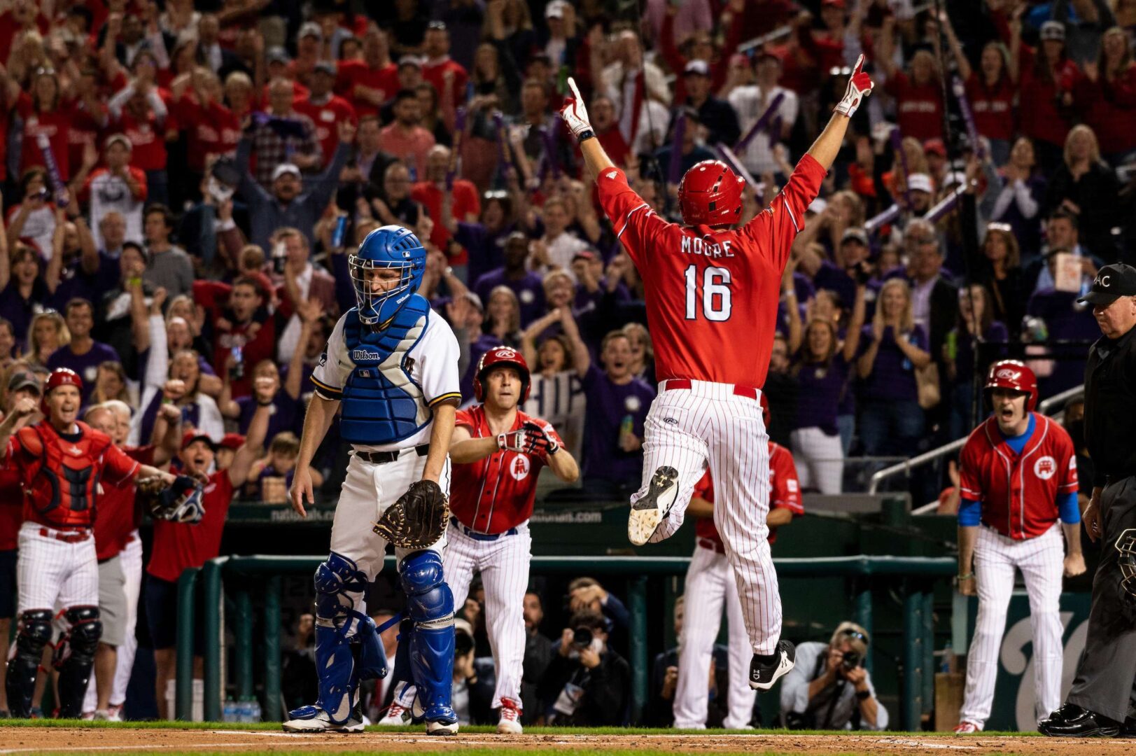 UNITED STATES - SEPTEMBER 29: GOPs Rep. Blake Moore, R-Utah, celebrates his inside the park home run as Democrats catcher Sen. Chris Murphy, D-Conn., looks on during the Congressional Baseball Game at Nationals Park in Washington on Wednesday, Sept. 29, 2021. (Photo by Bill Clark/CQ Roll Call)