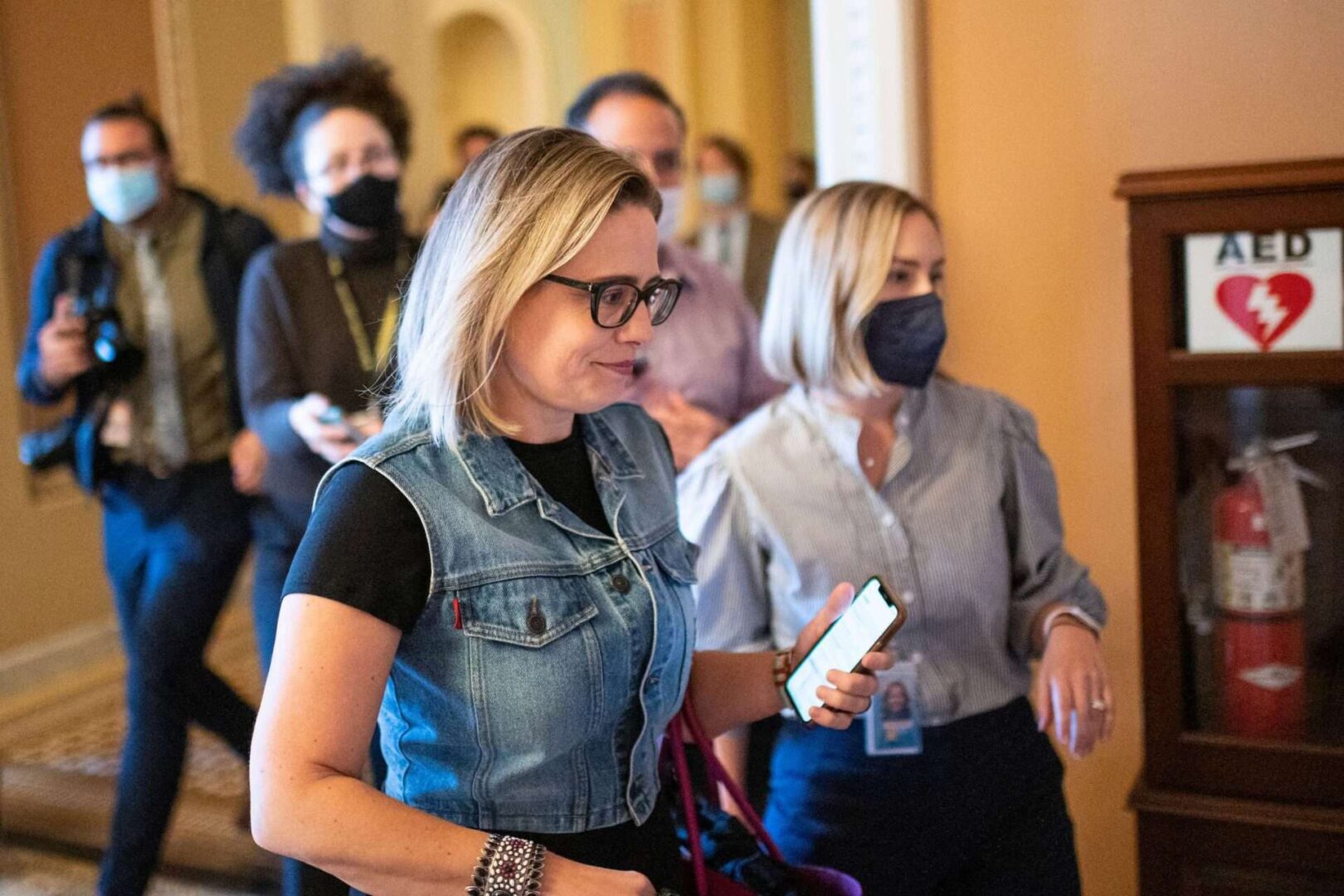 Sen. Kyrsten Sinema, D-Ariz., arrives for the Senate Democrats lunch in the Capitol on Tuesday, Oct. 26, 2021. 