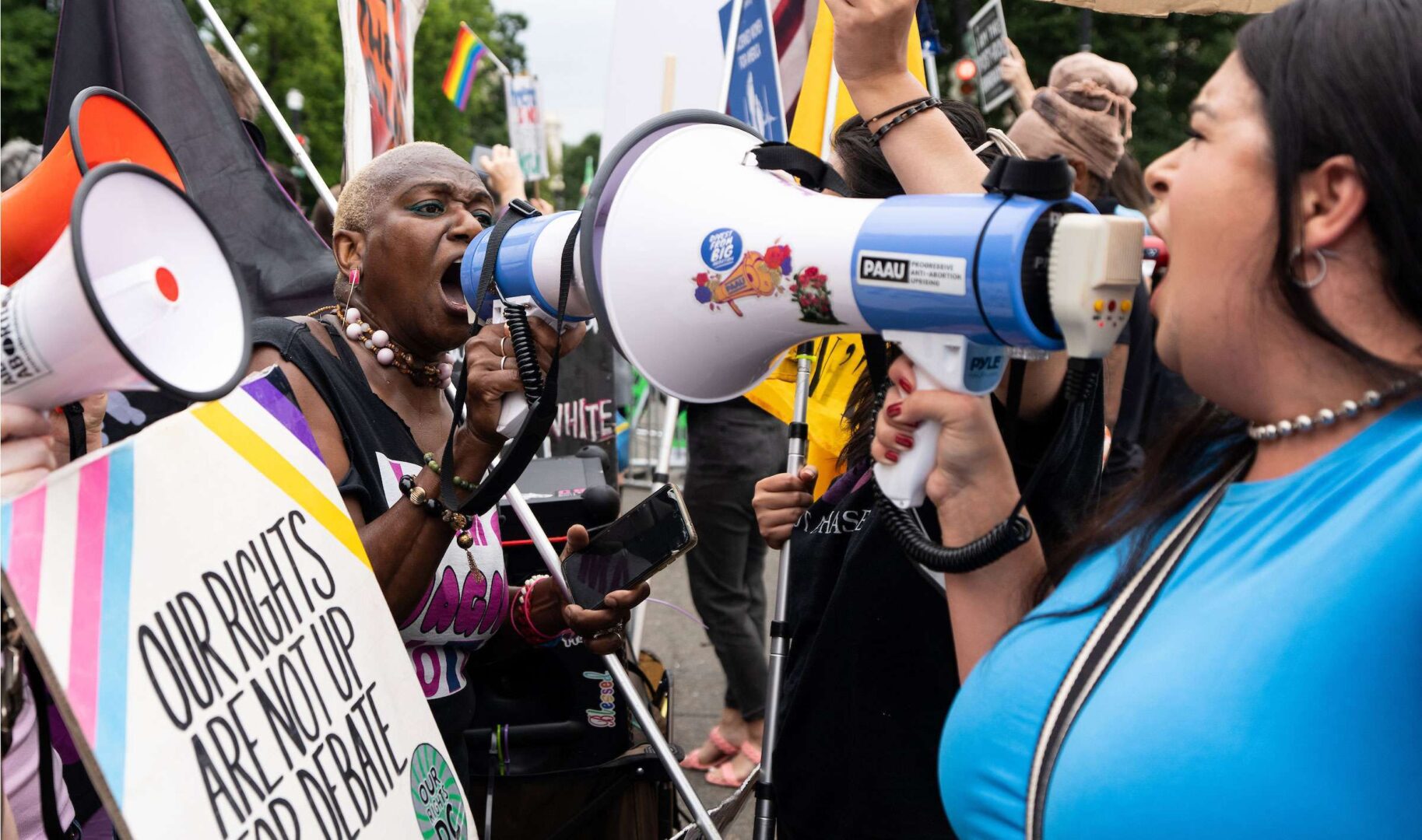 Abortion rights and anti-abortion activists use  megaphones outside the Supreme Court on Tuesday as they wait for justices to hand down their decision on Dobbs v. Jackson.