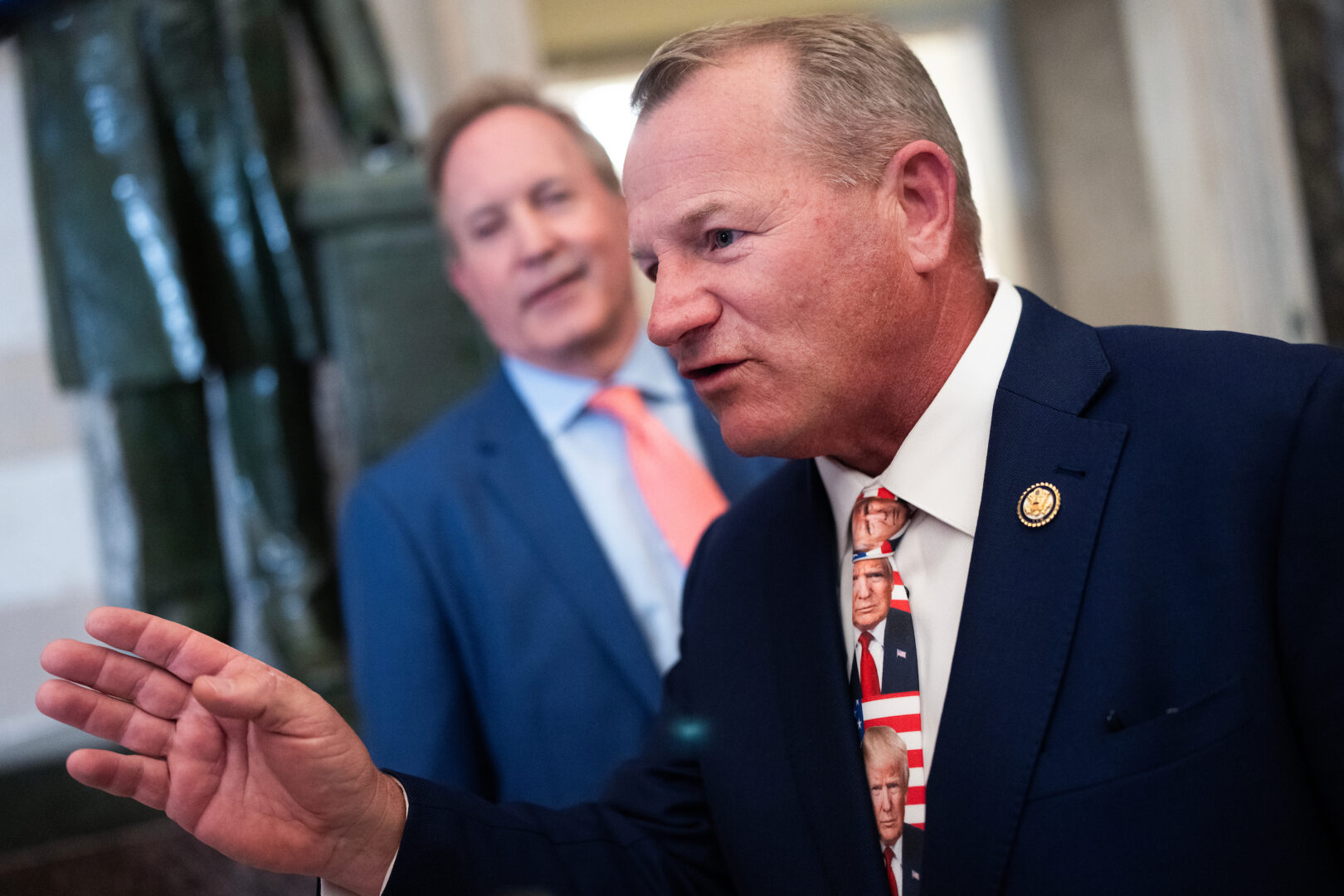 Rep. Troy Nehls, right, and Texas Attorney General Ken Paxton talk with reporters in the U.S. Capitol’s Statuary Hall before President Donald Trump’s State of the Union address on Feb. 24.