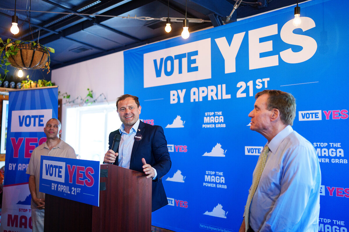 Former Virginia Rep. Tom Perriello speaks at a pro-redistricting rally in Charlottesville on April 11 as House Minority Leader Hakeem Jeffries, left, and Virginia Sen. Mark Warner look on.