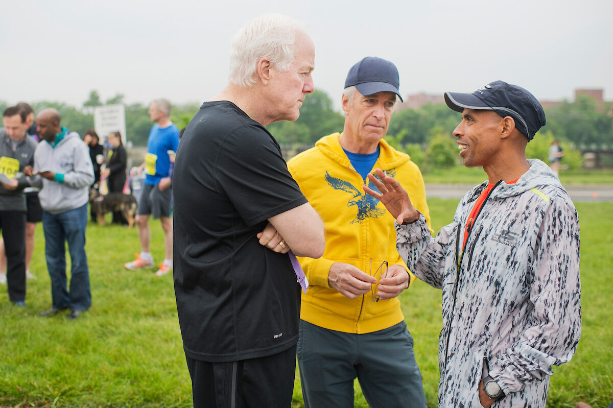 From left, Sen. John Cornyn, R-Texas, ACLI President Dirk Kempthorne, and Olympic runner Meb Keflezighi talk before the ACLI Capital Challenge Three-Mile Team Race in Anacostia Park on May 18, 2016.