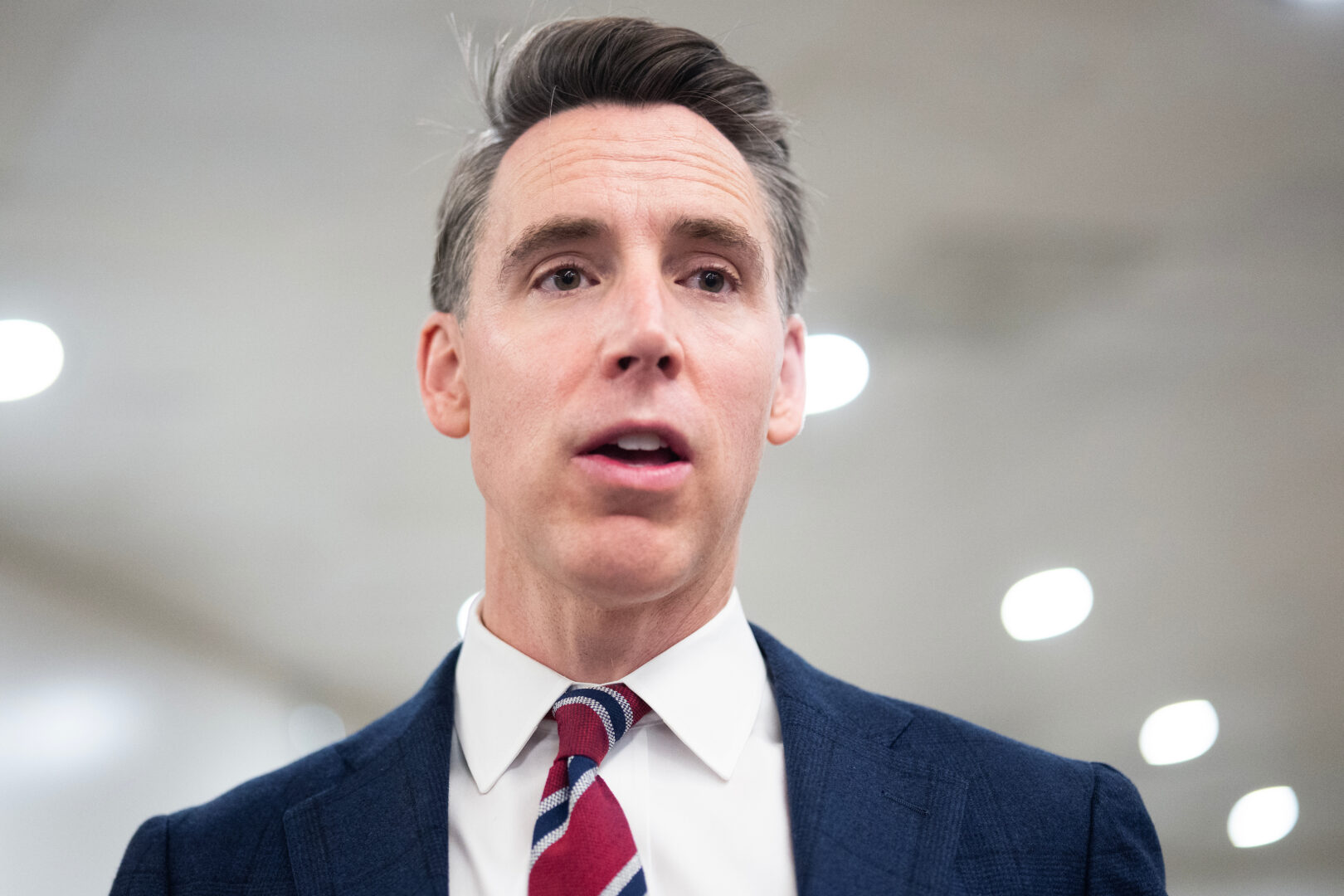 Sen. Josh Hawley, R-Mo., talks with reporters in the Capitol on Thursday. HIs bill that would restrict companion chatbots to adults was advanced in committee. 