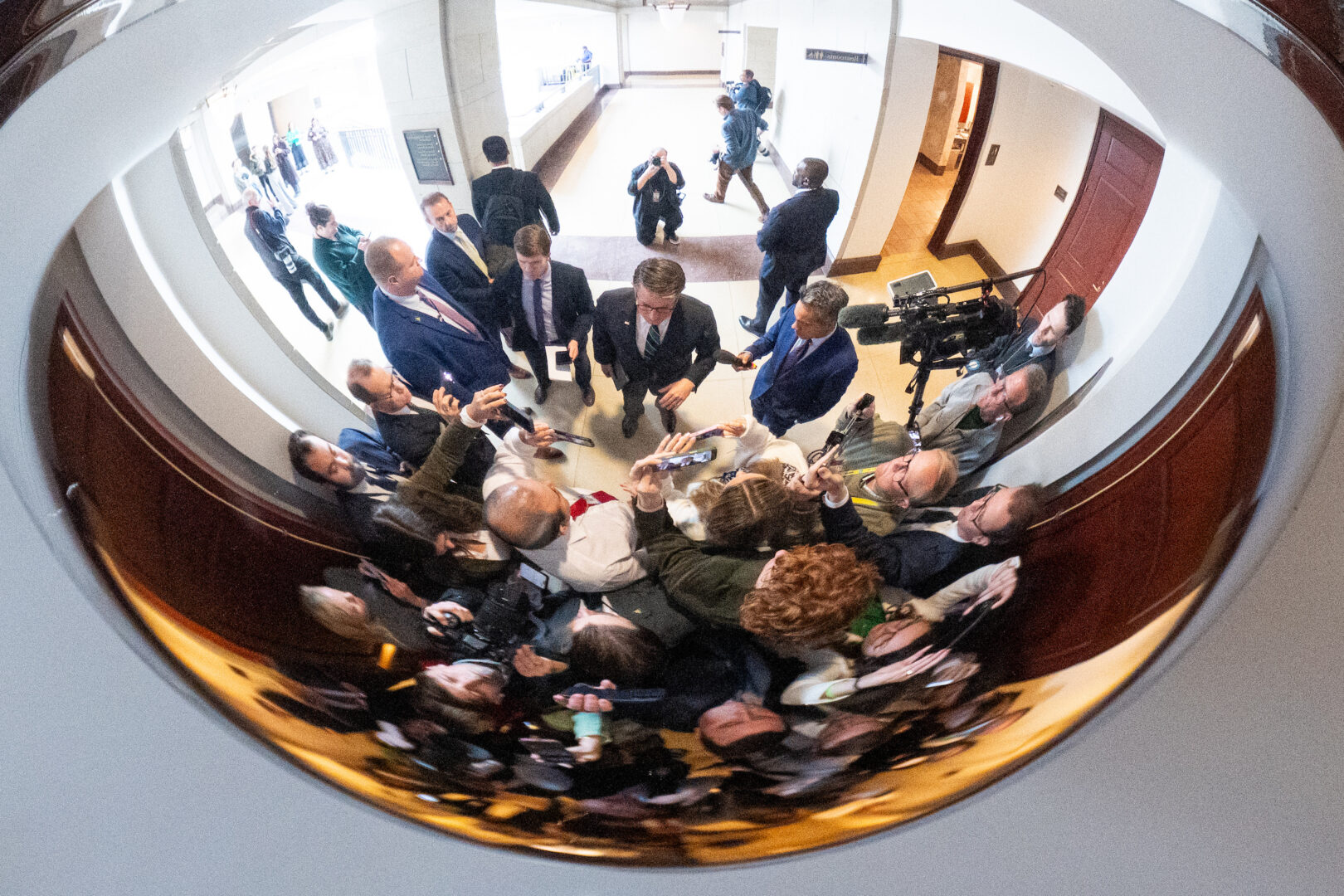 Speaker Mike Johnson, R-La., stops to gaggle with reporters after a news conference in the Capitol last month. 
