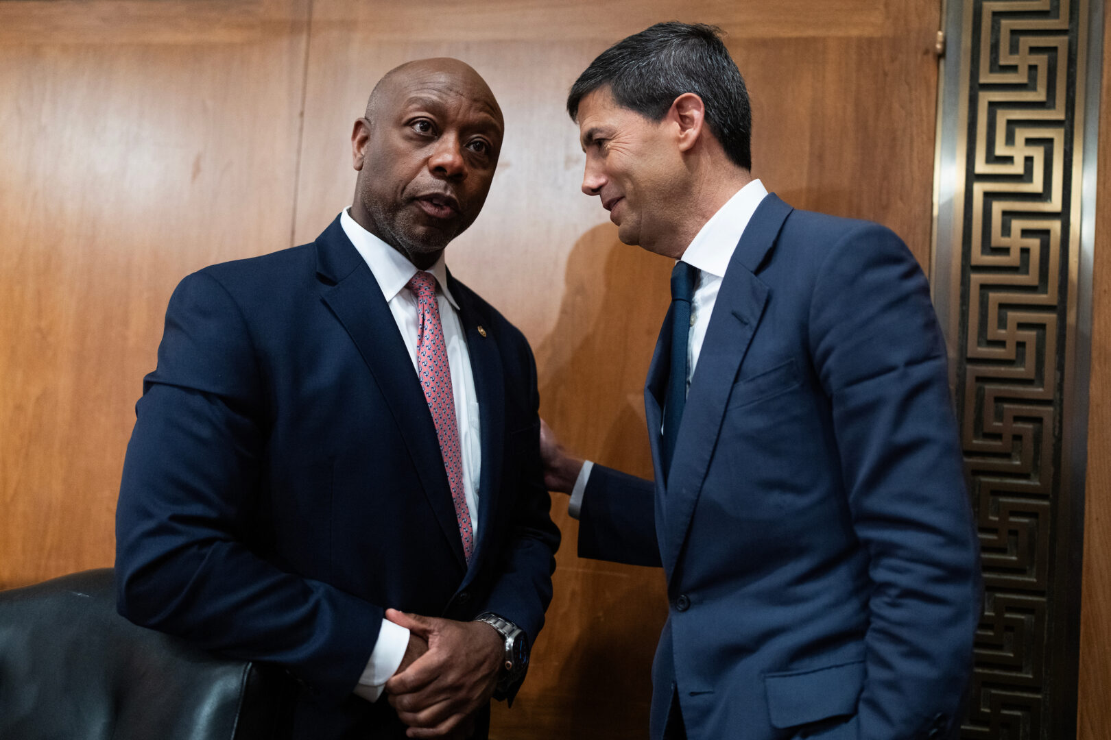 Kevin Warsh, right, nominee to chairman of the Federal Reserve, talks with Senate Banking Chairman Tim Scott, R-S.C., after his confirmation hearing Tuesday.