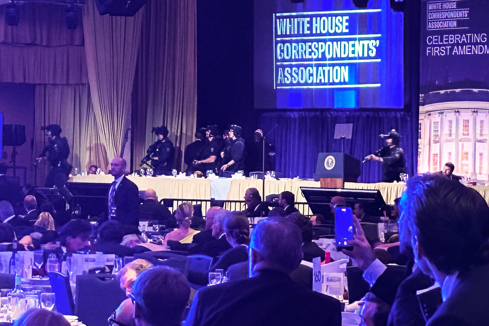 Secret Service agents respond on the dais at the White House Correspondents’ Association Dinner after shots were fired near the ballroom of the Washington Hilton on Saturday night. (Jason Dick/CQ Roll Call)
