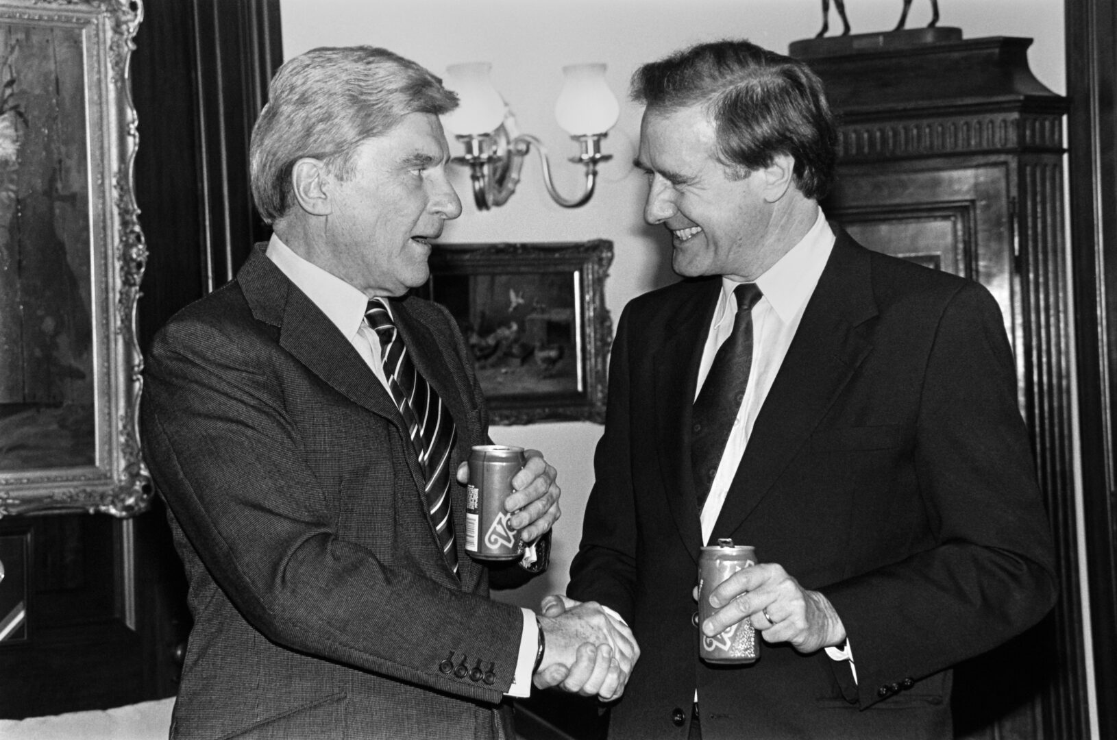 Sen. Donald W. Riegle, D-Mich., right, shakes hands with Sen. John W. Warner, R-Va., in January 1992. 