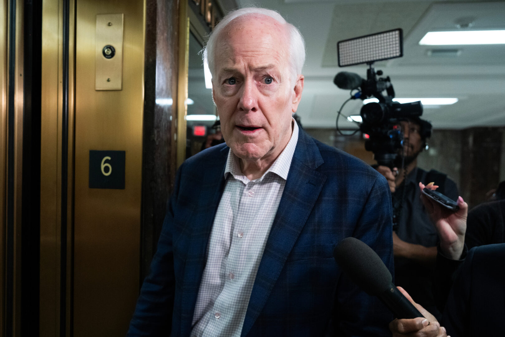 Sen. John Cornyn, R-Texas,  talks with reporters after a Senate Budget Committee markup on Wednesday, May 20, 2026. President Donald Trump endorsed Cornyn’s opponent Ken Paxton in the Texas Senate primary. 