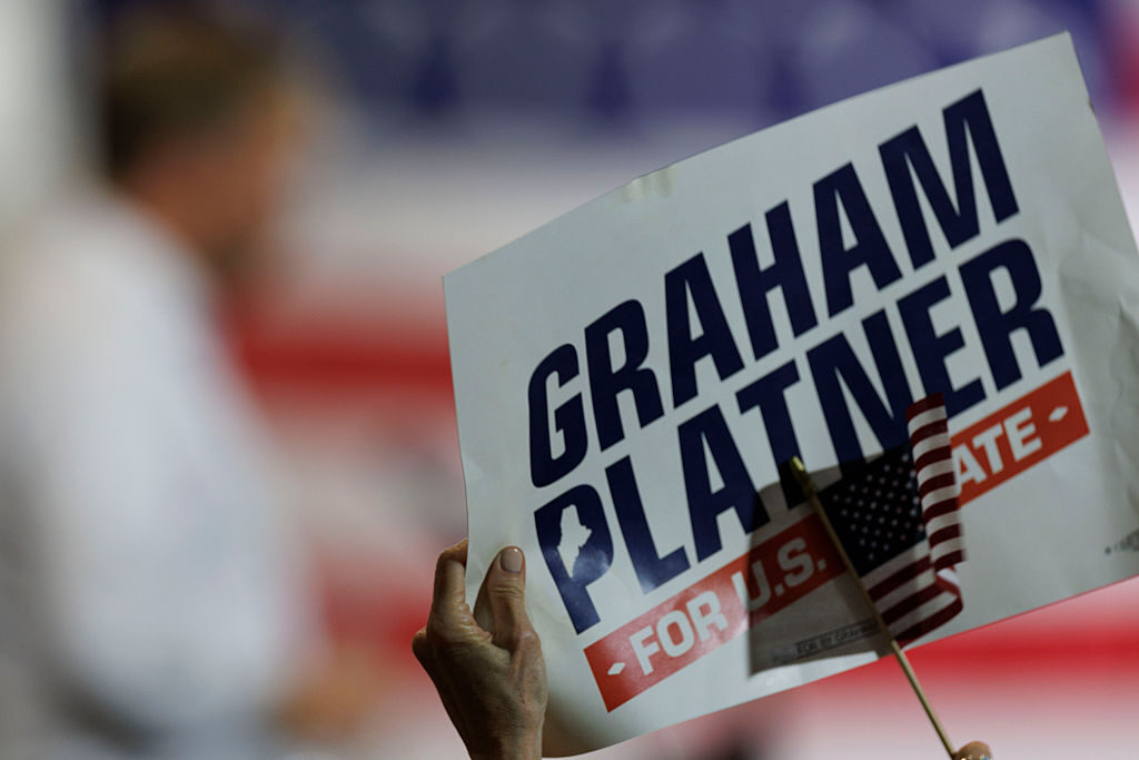 A supporter of Graham Platner holds a campaign sign as the Democratic Senate candidate speaks during his election night event Tuesday in Blue Hill, Maine. (CJ Gunther/Getty Images)