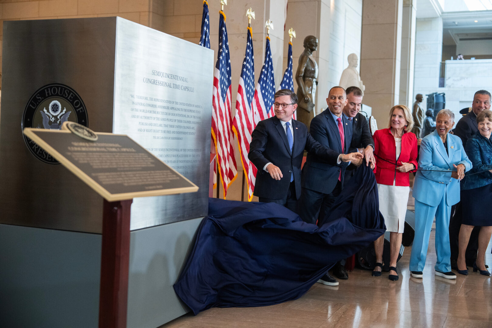 From left, Speaker of the House Mike Johnson, R-La., House Minority Leader Hakeem Jeffries, D-N.Y., Architect of the Capitol Thomas E. Austin, Sen. Shelley Moore Capito, R-W.Va., Rep. Bonnie Watson Coleman, D-N.J., Sens. Jeanne Shaheen, D-N.H., and Alex Padilla, D-Calif., unveil the  Semiquincentennial Congressional Time Capsule during a ceremony in Emancipation Hall on Wednesday. The capsule will be sealed for 250 years until July 4, 2276.